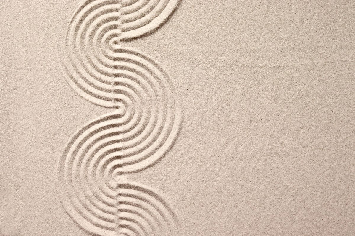 Calm raked sand in a curved pattern